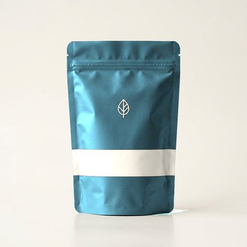 Teal Annasati pouch with a cream band, packaging concept